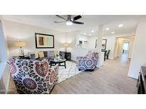 Bright living room with comfy seating and a view into the kitchen at 2064 S Farnsworth Dr # 18, Mesa, AZ 85209