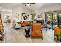 Open living room with a fireplace, comfortable seating, and access to other rooms at 15050 N Thompson Peak Pkwy # 2053, Scottsdale, AZ 85260