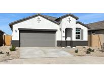 One-story home with gray garage door and desert landscaping at 40030 W Venture Rd, Maricopa, AZ 85138