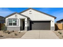 New single-story home with a two-car garage and desert landscaping at 40080 W Venture Rd, Maricopa, AZ 85138