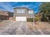 Two-story house with a two-car garage and landscaped front yard at 14850 W Laurel Ln, Surprise, AZ 85379