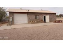 Detached garage with concrete slab and storage area at 30138 W Roosevelt St, Buckeye, AZ 85396