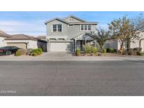 Two-story house with gray siding, two-car garage, and landscaping at 9814 E Palladium Dr, Mesa, AZ 85212