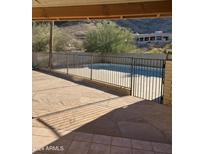 Inviting backyard pool with a metal fence at 11581 S 28Th Ave, Laveen, AZ 85339