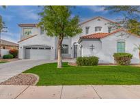 Two-story house with gray siding, a three-car garage, and a manicured lawn at 18548 E Purple Sage Dr, Queen Creek, AZ 85142