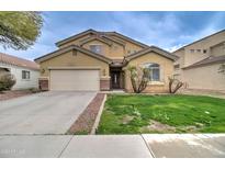 Two-story house with a large yard, driveway, and attached garage at 5659 S 239Th Dr, Buckeye, AZ 85326