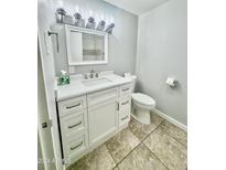 Updated bathroom features a vanity with white cabinets and gray tile floors at 6125 E Indian School Rd # 167, Scottsdale, AZ 85251