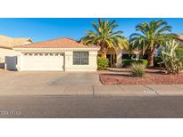 Single-story home with a two-car garage and desert landscaping at 6722 W Piute Ave, Glendale, AZ 85308