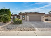 Single-story home with a two-car garage and desert landscaping at 15303 W Paradiso Ct, Surprise, AZ 85374