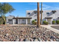 Front view of a remodeled light-colored stucco building with a rock garden at 2415 N 71St St # D, Scottsdale, AZ 85257