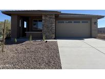 One-story home with a two-car garage and desert landscaping at 33339 N 132Nd Dr, Peoria, AZ 85383