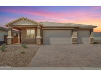 Single-story home with two-car garage and landscaped front yard at 6404 N 190Th Dr, Waddell, AZ 85355