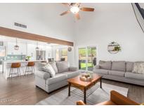 Bright living room features vaulted ceilings, hardwood floors, and an open floor plan at 12705 N 89Th Pl, Scottsdale, AZ 85260