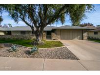 Single-story home with landscaped yard and attached garage at 18435 N 125Th Ave, Sun City West, AZ 85375