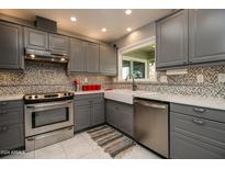 Modern kitchen with stainless steel appliances and white sink at 18435 N 125Th Ave, Sun City West, AZ 85375
