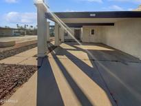 Sunlit front view of single-story home with carport and landscaped yard at 3007 W Redfield Rd, Phoenix, AZ 85053