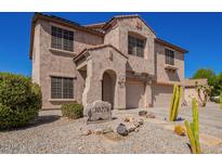 Two-story house with desert landscaping and a large driveway at 30276 W Crittenden Ln, Buckeye, AZ 85396