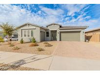 Single-story home with two-car garage and landscaped front yard at 14196 W Gray Fox Trl, Surprise, AZ 85387