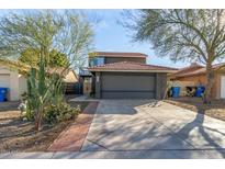 Two-story house with a gray garage door and landscaped front yard at 4607 E Piedmont Rd, Phoenix, AZ 85044