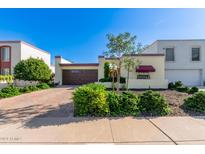Spanish style home with a brick driveway and mature landscaping at 6317 E Pinchot Ave, Scottsdale, AZ 85251