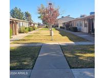 Neat community with grassy areas and walkways at 849 N Revere St # B, Mesa, AZ 85201