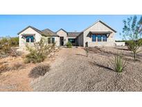 Single-story home with light-colored exterior and landscaped yard at 8714 E Tether Trl, Scottsdale, AZ 85255