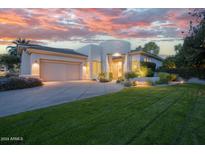 Luxury home with landscaped lawn and a stunning sunset view at 8745 N 73Rd Way, Scottsdale, AZ 85258