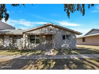 Front view of a charming single-story home with a well-maintained lawn at 225 N Standage -- # 40, Mesa, AZ 85201