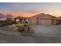 One-story home with a two-car garage and desert landscaping at 7979 E Evening Glow Dr, Scottsdale, AZ 85266