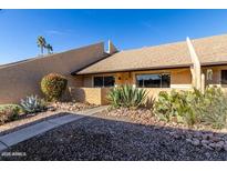 Charming condo with desert landscaping and a walkway at 8055 E Thomas Rd # D115, Scottsdale, AZ 85251