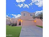 Two-story house with a landscaped lawn and attached garage at 9462 N 94Th Ln, Peoria, AZ 85345