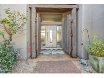 Inviting entryway with rustic wood doors and a tiled walkway at 10040 E Happy Valley Rd # 2001, Scottsdale, AZ 85255