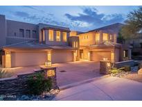 Luxury home with three-car garage, and beautiful desert landscaping at dusk at 14850 E Grandview Dr # 242, Fountain Hills, AZ 85268