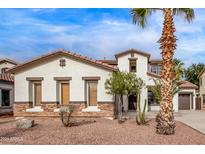 Two-story house with stucco exterior, tile roof, and desert landscaping at 19668 E Carriage Way, Queen Creek, AZ 85142