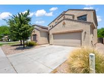 Two-story house with a large driveway and landscaping at 5677 S 239Th Dr, Buckeye, AZ 85326