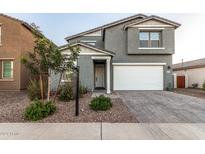 Two-story house with gray siding, white garage door, and landscaped front yard at 11311 E Upton Ave, Mesa, AZ 85212
