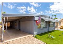Mobile home with carport and landscaped lawn at 6828 W Pierce St # 126, Phoenix, AZ 85043