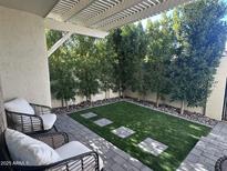 Private backyard patio with artificial turf and seating area at 7925 E Keim Dr, Scottsdale, AZ 85250