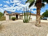 Single-story home with solar panels, desert landscaping, and a two-car garage at 15420 N 160Th Ln, Surprise, AZ 85374