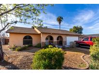 Ranch style home with landscaped yard, attached garage, and driveway at 5147 W Seldon Ln, Glendale, AZ 85302