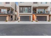 Modern townhome exterior with two-car garage and private balcony at 6850 E Mcdowell Rd # 26, Scottsdale, AZ 85257