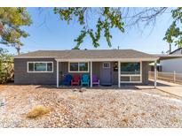 Gray house with covered porch, colorful chairs, and rock landscaping at 7039 E Virginia Ave, Scottsdale, AZ 85257