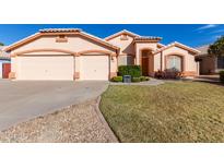 Single-story house with two-car garage and well-maintained lawn at 7802 E Covina St, Mesa, AZ 85207