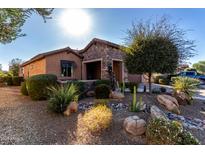 Single-story home with stone accents and landscaped front yard at 26653 W Firehawk Dr, Buckeye, AZ 85396