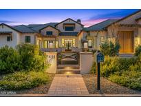 Stunning farmhouse exterior with brick accents and a gated entryway at 11438 N 70Th St, Scottsdale, AZ 85254