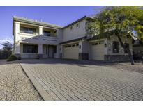 Two-story house with a three-car garage and a brick paved driveway at 1340 E Kingman Pl, Casa Grande, AZ 85122