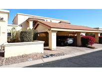 Spanish style condo with carport and well-manicured landscaping at 16734 E Gunsight Dr # 107, Fountain Hills, AZ 85268