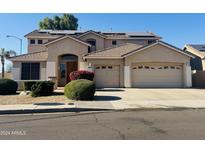 Two-story house with solar panels, landscaped yard, and a three-car garage at 26210 N 69Th Ln, Peoria, AZ 85383