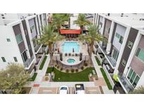 Aerial view of community pool with surrounding patio and building at 4444 N 25Th St # 15, Phoenix, AZ 85016