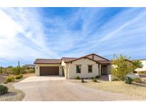 Single-story home with a terracotta tile roof and landscaped front yard at 562 N Sun Rd, Apache Junction, AZ 85119